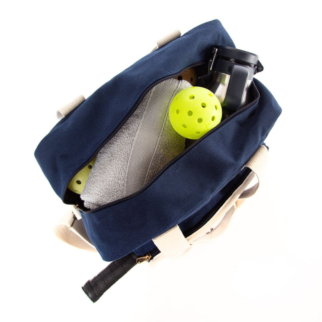 Embroidered Personalized Pickleball Bag in Navy Blue with natural color Handles in practical use